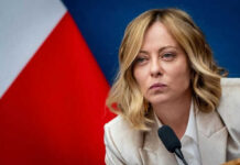 Italy’s Bold Rise Shakes French Dominance Person speaking at a conference with flag background