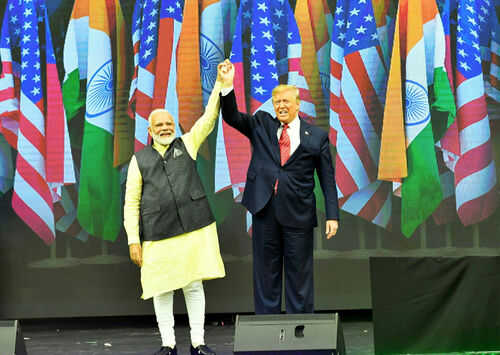 us-india-trump-modi1967957731jpg Two men holding hands on stage with flags behind