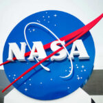 NASA logo with blue background and red swoosh.