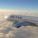 United airplane flying above clouds in the sky