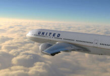 United airplane flying above clouds in the sky