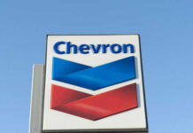 Chevron logo sign against blue sky