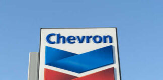 Chevron logo sign against blue sky