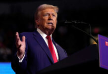 Trump’s Iran Objectives: Victory or Endless Conflict? Man speaking at a podium with microphone