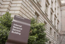 High-Stakes Probe: Are Nonprofits Funding Violence? IRS building sign outside government building with greenery