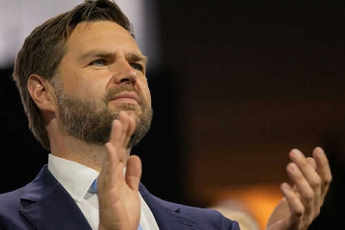 jd-vance2497649807 Person clapping enthusiastically in formal attire