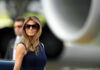 Melania’s Bold Move Against Foster System Failure I dont know who this is sunglasses blue dress