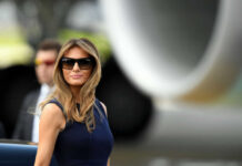 Melania’s Bold Move Against Foster System Failure I dont know who this is sunglasses blue dress