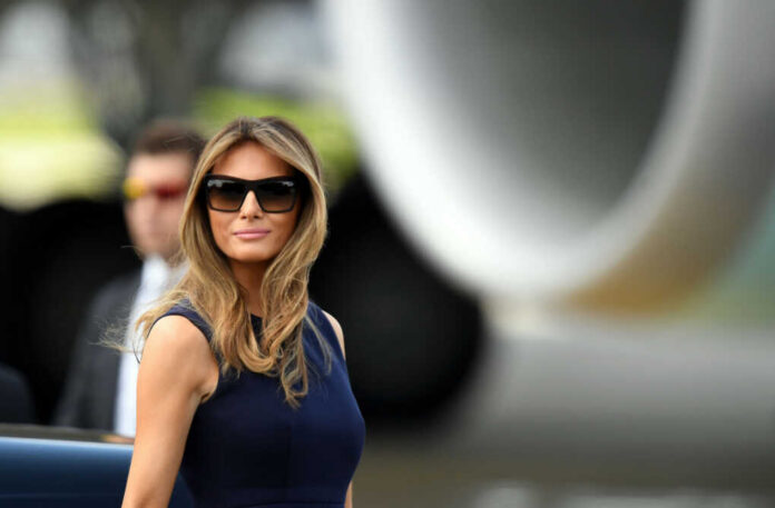 melania-trump711238588jpg I dont know who this is sunglasses blue dress