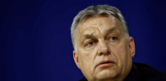 A political leader with a serious expression during a press conference