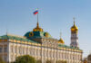 The Kremlin building with the Russian flag and golden domes in the background