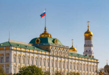The Kremlin building with the Russian flag and golden domes in the background