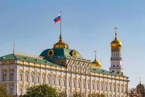 shutterstock_1442206805.jpg The Kremlin building with the Russian flag and golden domes in the background