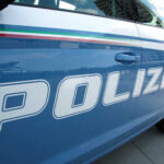 Close-up of a blue police car with the word 'POLIZIA' displayed