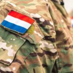 Close-up of a military uniform with a national flag patch