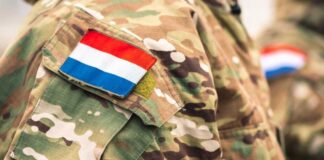 Close-up of a military uniform with a national flag patch