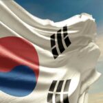 Waving South Korean flag with a blue sky background