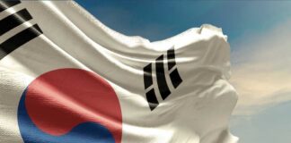Waving South Korean flag with a blue sky background