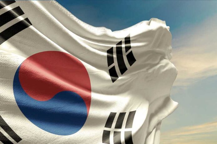Waving South Korean flag with a blue sky background