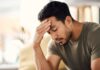 Brain Tumors Mistaken for Anxiety – Deadly Overlap A man with a pained expression, holding his forehead in a moment of distress