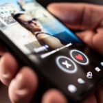 Close-up of a hand holding a smartphone displaying a dating app interface
