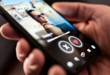 Close-up of a hand holding a smartphone displaying a dating app interface