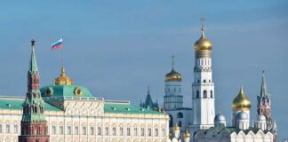 View of the Kremlin with golden domes and the Russian flag