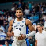Basketball player in a team jersey walking off the court