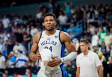 Basketball player in a team jersey walking off the court