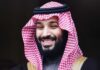 A man in traditional Saudi attire smiling at the camera