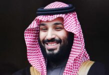 A man in traditional Saudi attire smiling at the camera