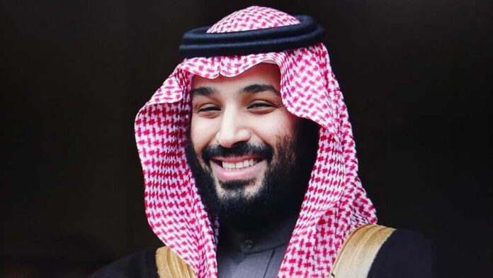 A man in traditional Saudi attire smiling at the camera