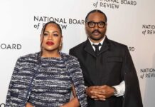 A couple posing at a red carpet event for the National Board of Review