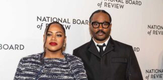 A couple posing at a red carpet event for the National Board of Review
