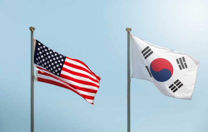 Flags of the United States and South Korea waving in the wind