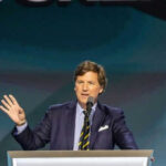 Person speaking at a podium with microphone