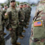 Military personnel standing in formation outdoors