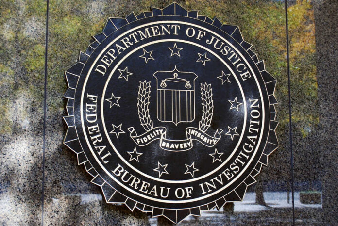 fbi_id_1733876597.jpg FBI seal against marbled wall background.