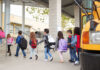 Group of children walking towards a school bus