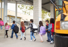 Group of children walking towards a school bus