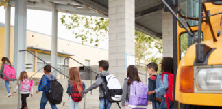 Group of children walking towards a school bus