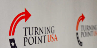 Logo of Turning Point USA displayed on a backdrop