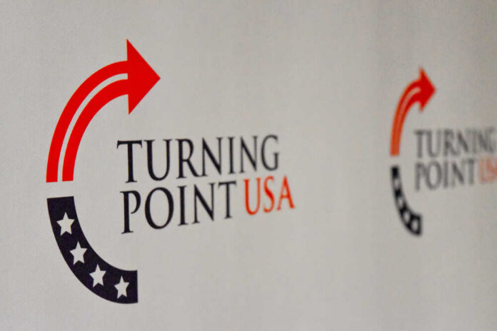 Logo of Turning Point USA displayed on a backdrop