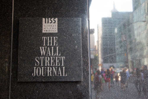 shutterstock_1301601253.jpg Sign for The Wall Street Journal on a building in a busy city street