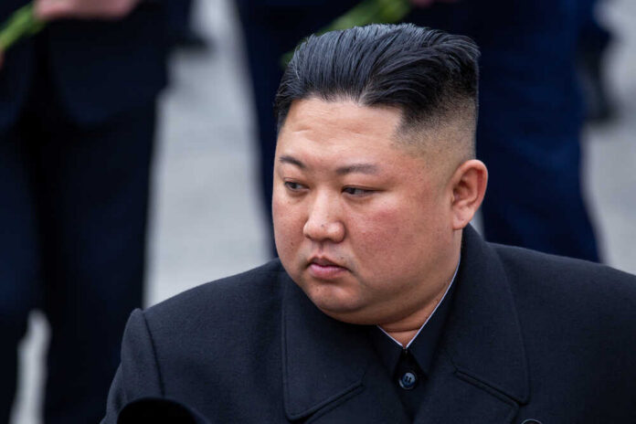 A political figure in formal attire with a serious expression