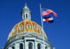 Shocking Legal Twist: Colorado’s New Bill Takes Aim The dome of a state capitol building with flags flying against a blue sky