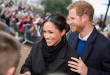 Netflix Dumps Meghan, Yet Welcomes Sussexes A smiling couple interacting with a crowd during a public event