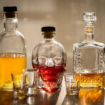A collection of decorative liquor bottles and shot glasses on a table