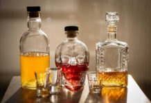 A collection of decorative liquor bottles and shot glasses on a table