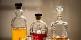 A collection of decorative liquor bottles and shot glasses on a table